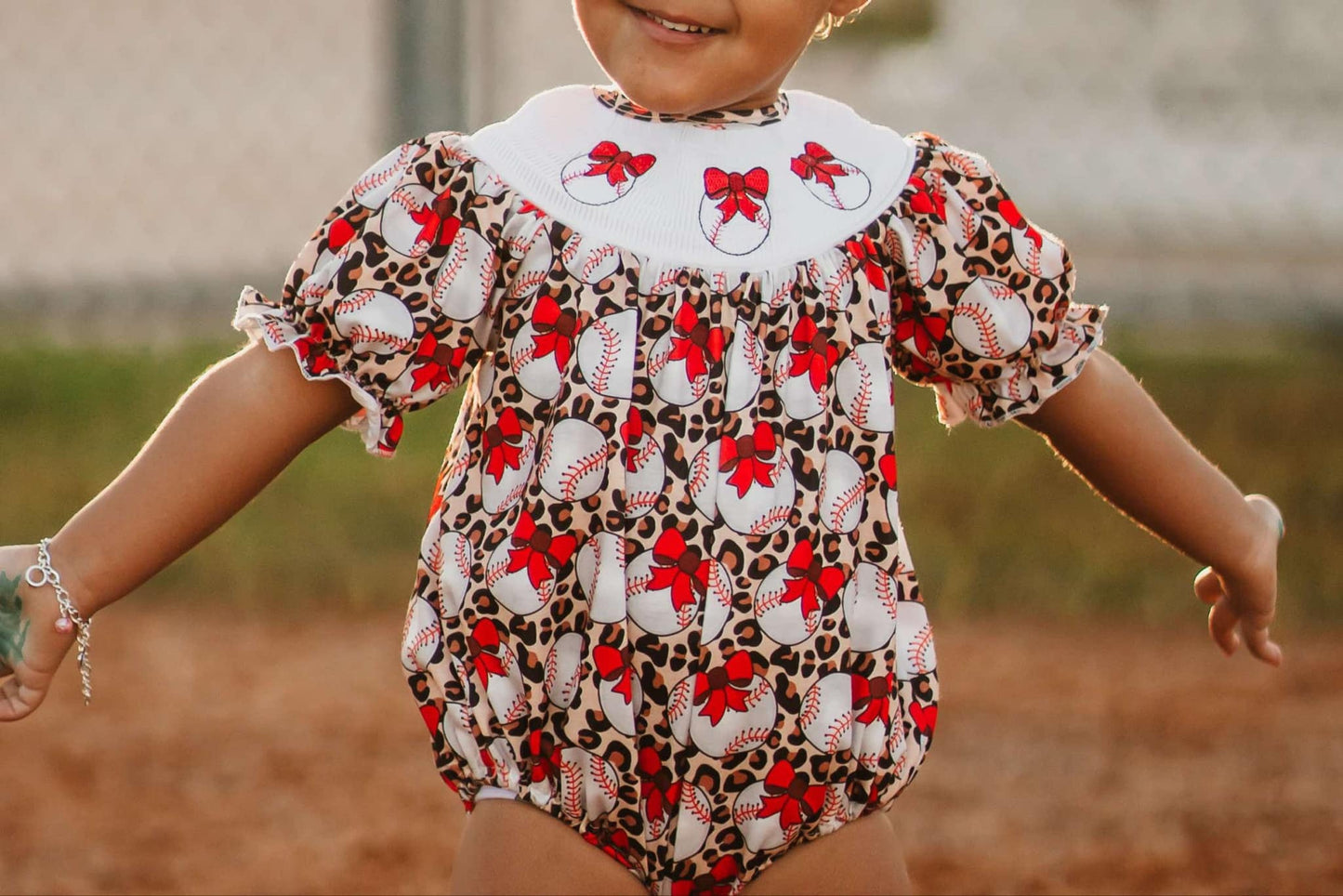 Smocked leopard baseball romper