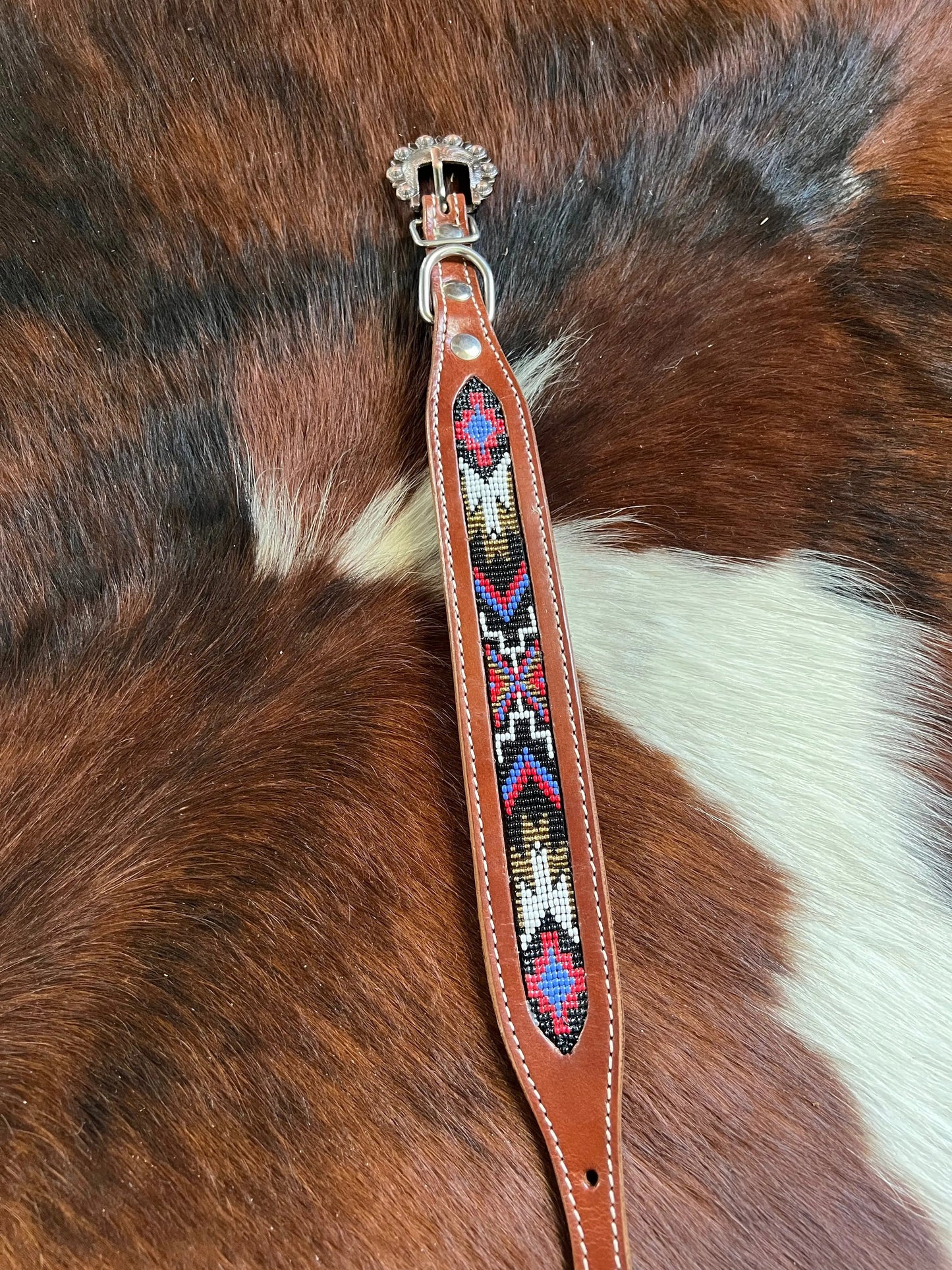 Genuine leather dog collar with red, black, periwinkle, white, and gold navajo beaded inlay design
